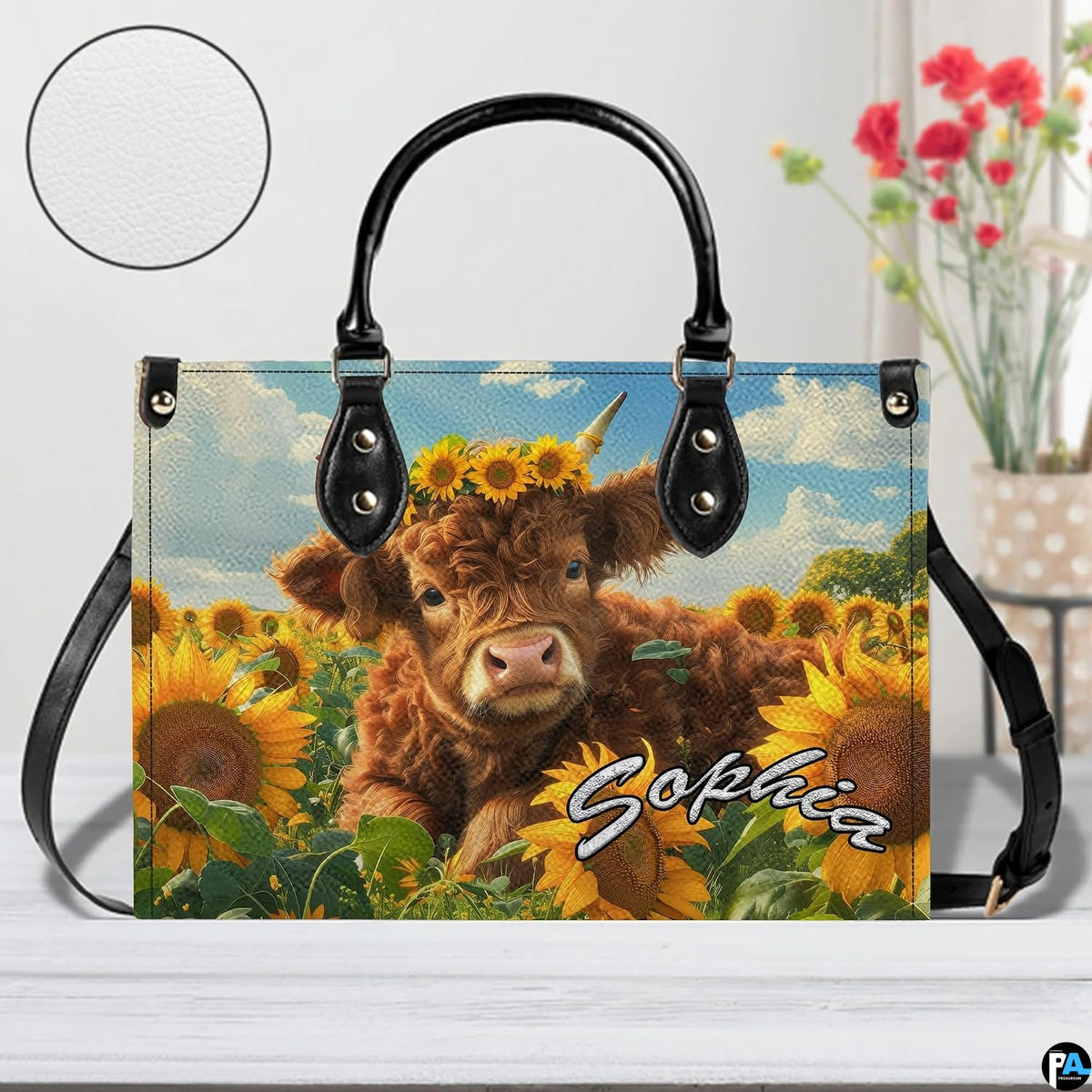 Studio presentation on light wooden planks featuring the floral crowned cow calf artwork and floral vase.