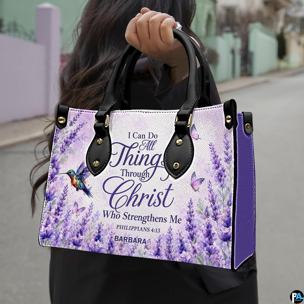 Model outdoors carrying lavender floral hummingbird handbag