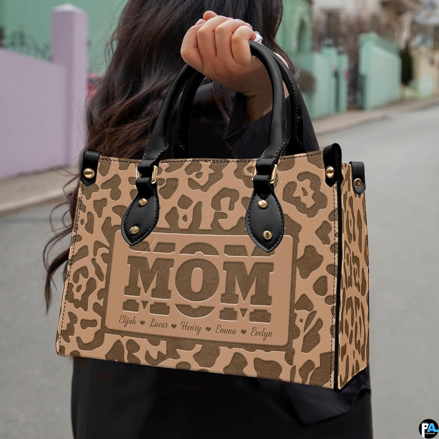 Model showcasing tan leopard print design outdoors along a sunlit pathway.