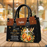 Hummingbird cross handbag displayed on wooden tabletop in front of sunlit cafe window.