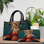 Devotional art handbag staged on an indoor tabletop with potted greenery