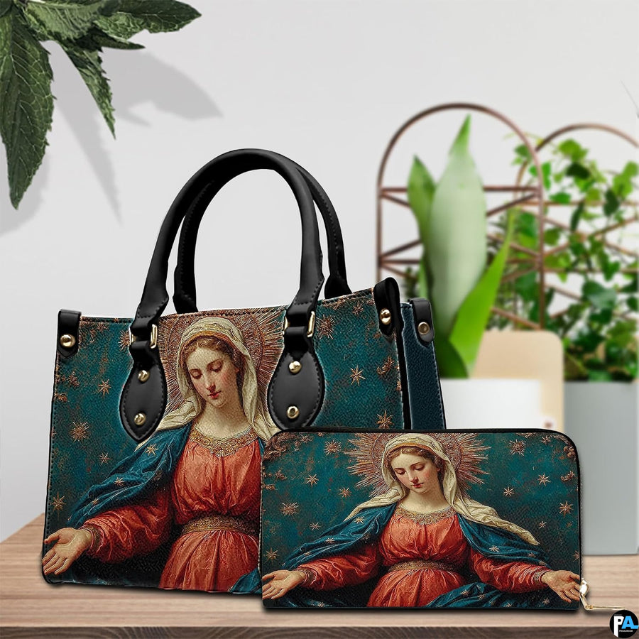 Devotional art handbag staged on an indoor tabletop with potted greenery