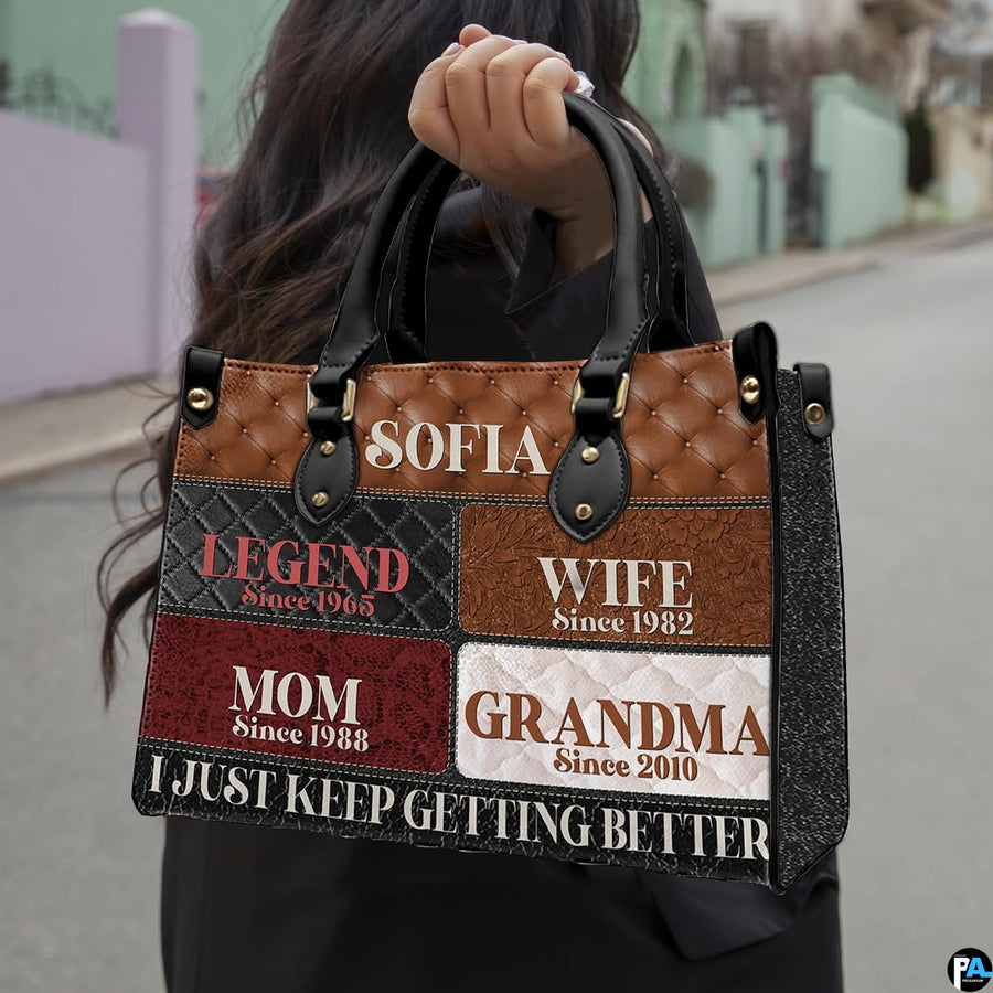 Front view of patchwork handbag featuring diamond tufted patterns and multi-toned rectangular blocks.