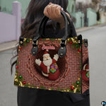 Front view of chimney purse showing Santa Claus, festive red brickwork, and illuminated pine boughs.