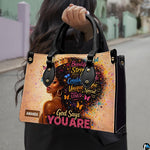 Model carrying afro queen handbag with colorful butterfly portrait