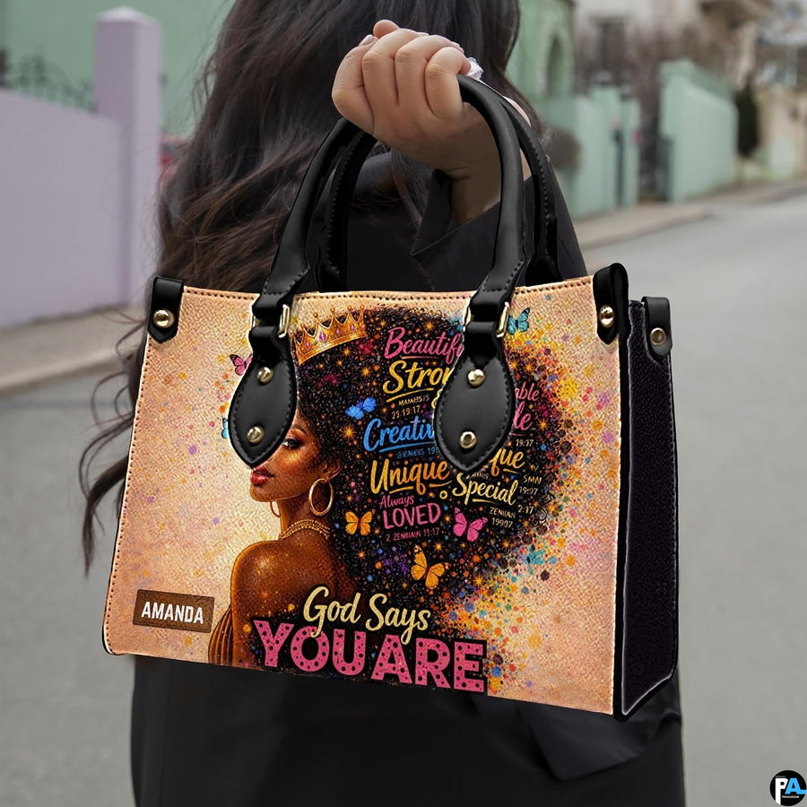 Model carrying afro queen handbag with colorful butterfly portrait