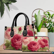 Vintage rose art accessory and companion item arranged together on timber tabletop near green potted foliage.