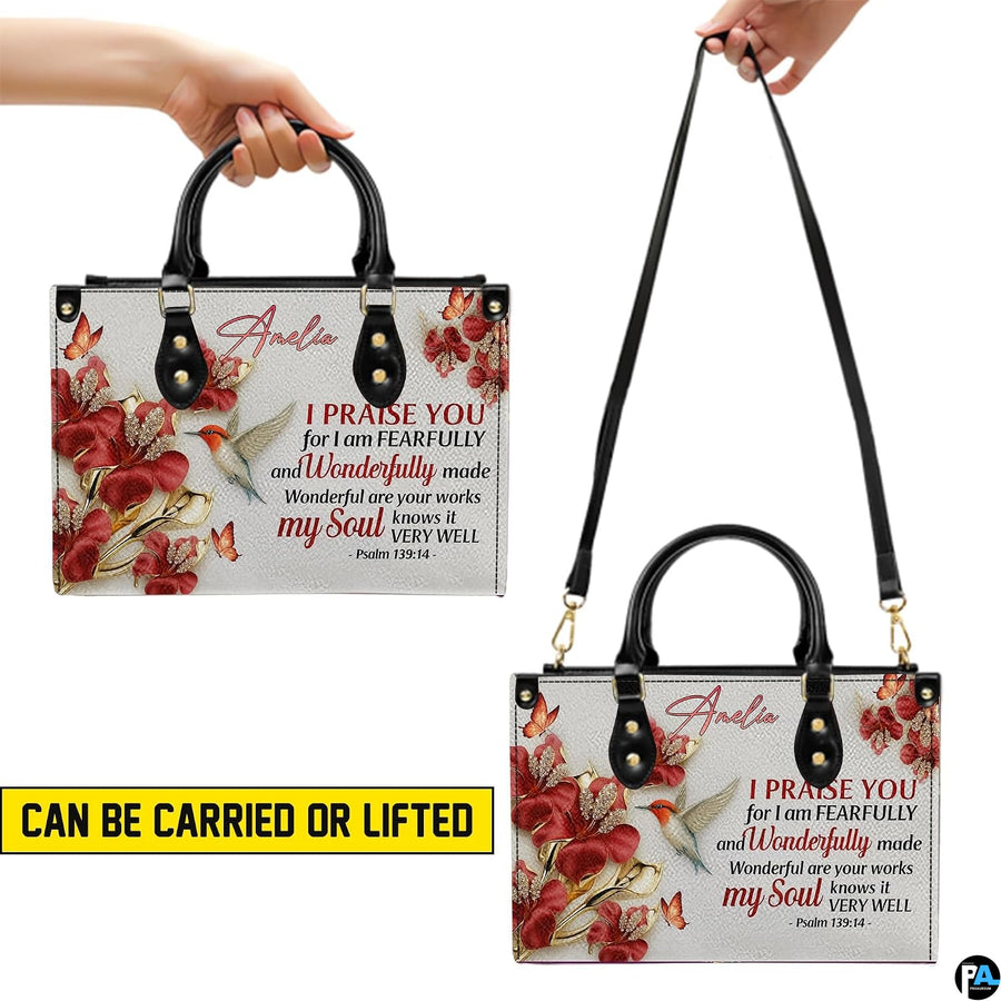 Outdoor lifestyle presentation showcasing the hummingbird floral devotional handbag held by a model.