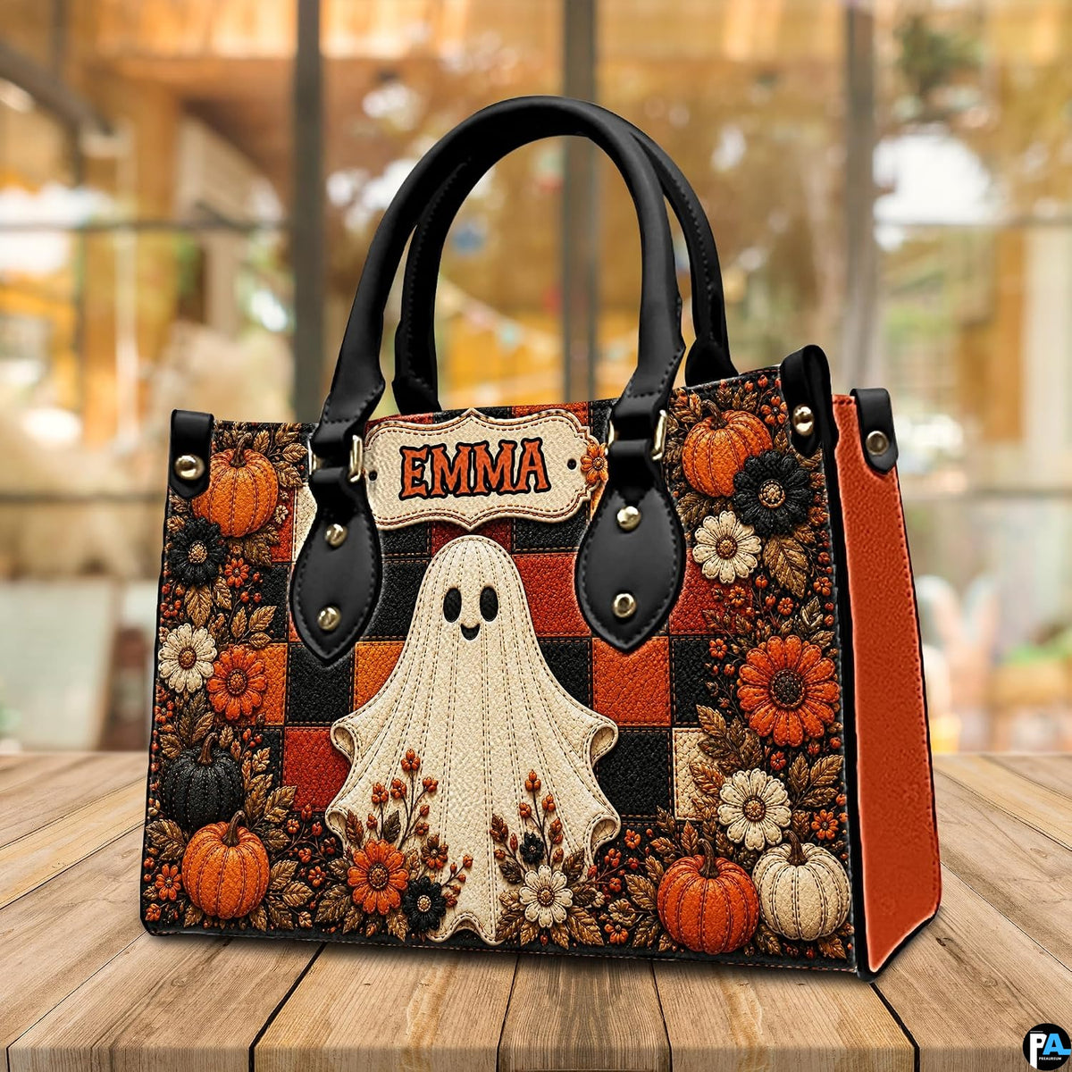 Outdoor perspective of the autumn ghost satchel positioned on a wooden patio table.