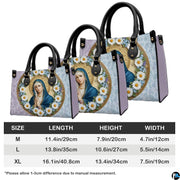 Detailed view of coordinating wallet with daisy-framed Virgin Mary portrait