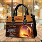 Empty tomb handbag displayed on wooden tabletop in a bright interior room