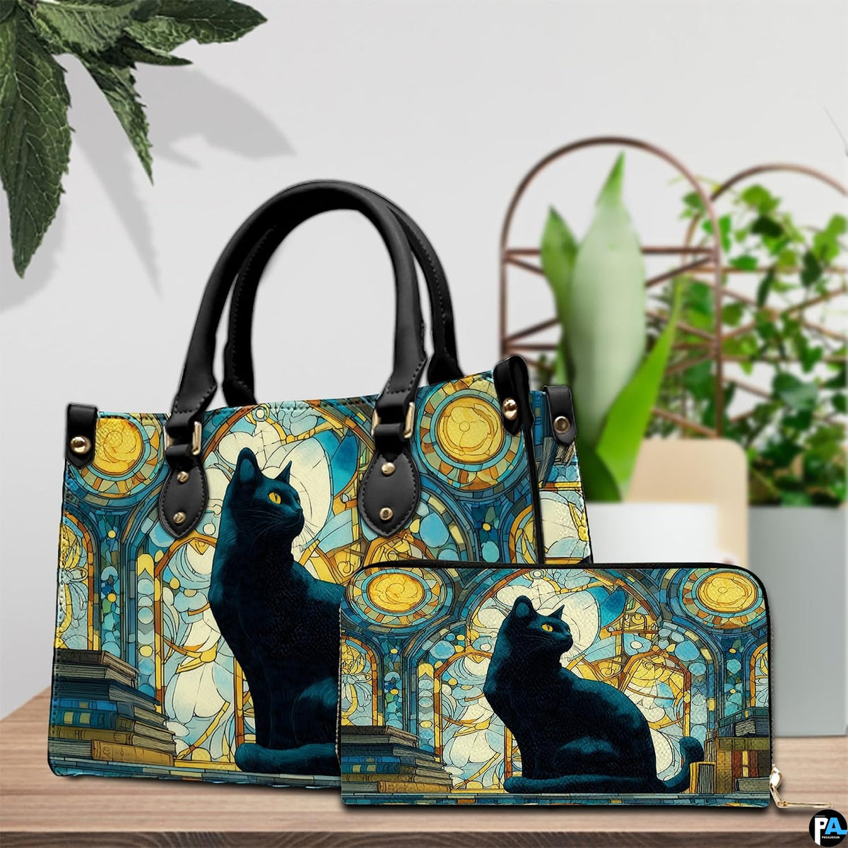 Tabletop arrangement showing cat on books stained glass art beside lush potted foliage.
