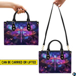 Top view of neon dragonfly handbag showing zipper closure and dual carrying handles