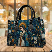 Madonna mosaic sacred art handbag resting on a wooden cafe tabletop with warm background lighting
