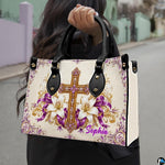 Woman carrying the purple crystal cross handbag outdoors in natural light.