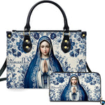 Front view of handbag and wallet set with praying Virgin Mary on blue floral ceramic tile background.
