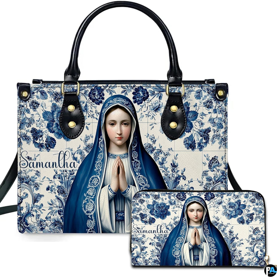 Front view of handbag and wallet set with praying Virgin Mary on blue floral ceramic tile background.