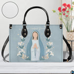 Minimalist Marian praying handbag displayed on white table with floral background