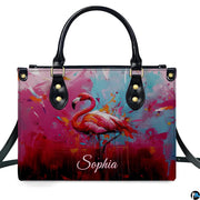 Street perspective of the colorful splatter flamingo shoulder bag.
