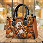 Ghost armchair satchel positioned on wooden table with warm seasonal bokeh lighting background.