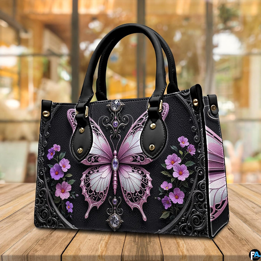 Front view of gothic butterfly handbag featuring pastel pink wings and purple wildflowers on black