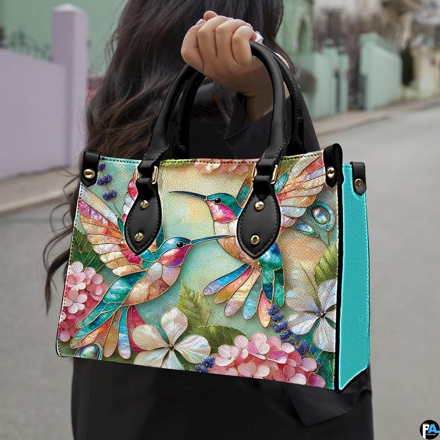 Angled display of mosaic bird purse paired with coordinating zippered companion wallet.