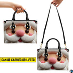 Carrying style demonstration showing top handle carry and shoulder strap wear for clay Santa handbag