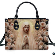 Front view of handbag displaying praying Virgin Mary encircled by lush blush pink and peach cabbage roses.