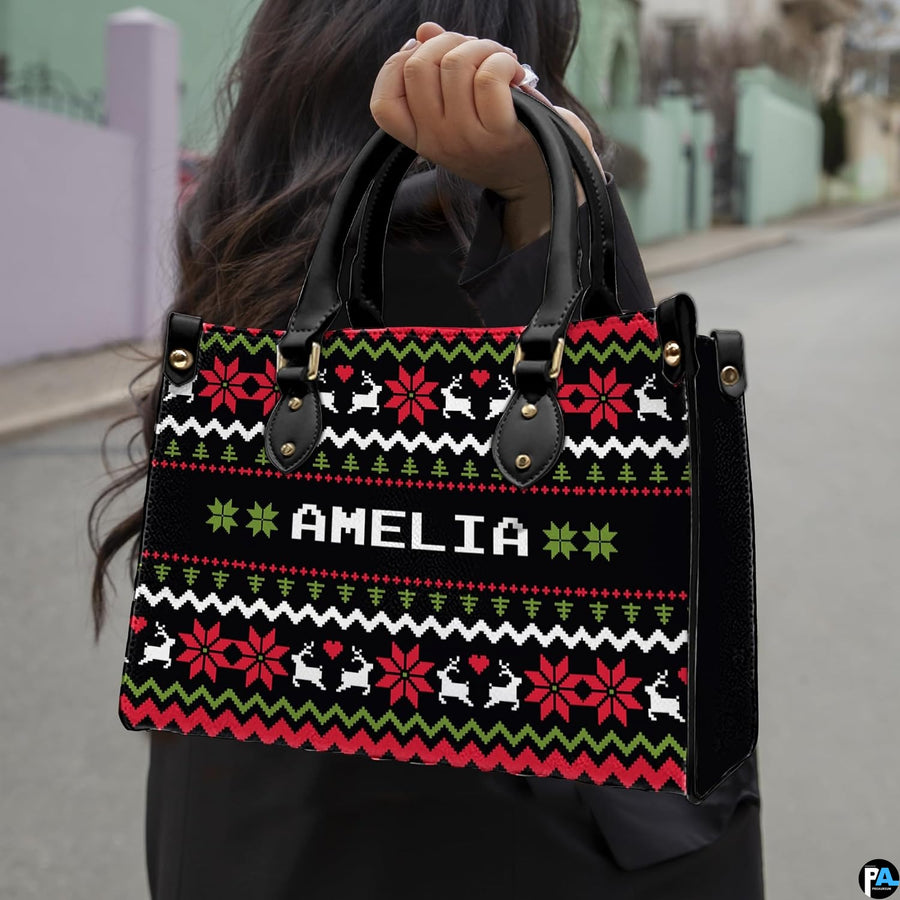 Front view of ugly sweater purse featuring horizontal knit bands of reindeer, hearts, and trees.