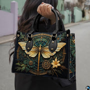 Matching zip-around wallet featuring golden dragonfly and Art Deco filigree medallion on dark teal