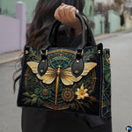 Matching zip-around wallet featuring golden dragonfly and Art Deco filigree medallion on dark teal