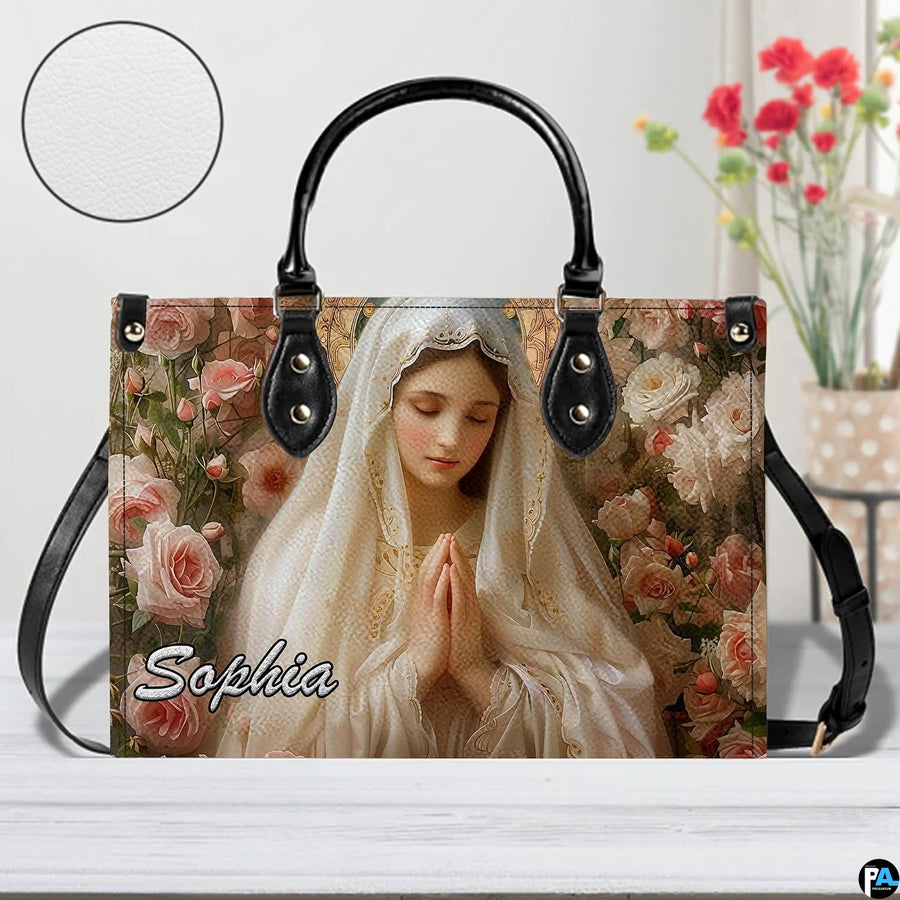Front view of ivory veil Virgin Mary handbag showing rose floral print with texture circle