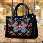 Embroidered butterfly floral handbag resting on a wooden tabletop in a bright cafe setting.