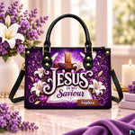 Purple cross devotional handbag displayed on a marble tabletop beside a vase of white lilies and candle.