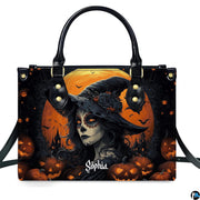 Halloween witch handbag and wallet displayed on wooden table beside potted plant.
