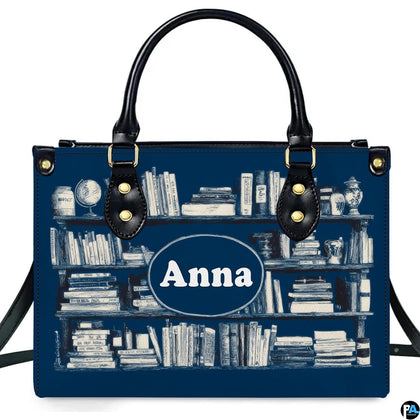 Front studio view of Navy Bookshelf Library Handbag with white engraved book spines on navy blue