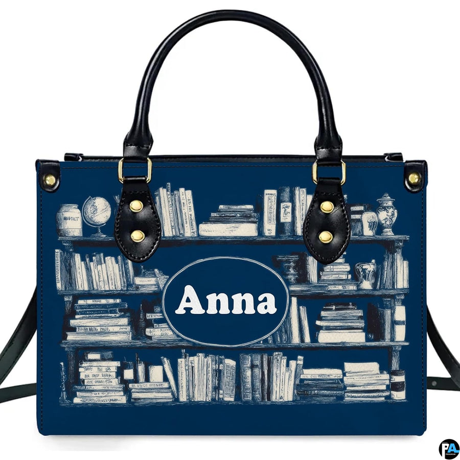 Front studio view of Navy Bookshelf Library Handbag with white engraved book spines on navy blue
