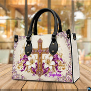 Purple and gold cross devotional handbag standing upright on a cafe table.