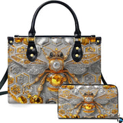 Front view of amber geometric honeycomb bee handbag and matching wallet set on silver background.