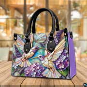 Front view of matching wallet showing coordinating mosaic hummingbirds and purple floral design.