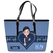 Front studio display of Denim Blue Clinician Tote Handbag featuring central heart graphic and pulse waveforms.