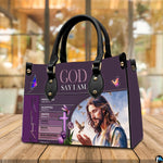 Jesus scripture handbag displayed on wooden tabletop in front of sunlit cafe window.