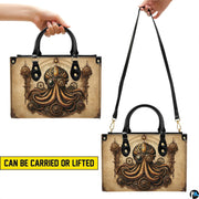 Bottom view of kraken handbag showing four protective gold base hardware feet