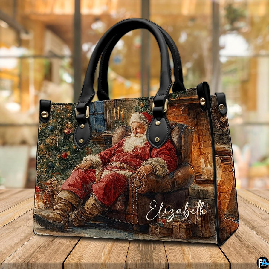 Perspective angle showing detailed fireside Santa Claus print on holiday handbag