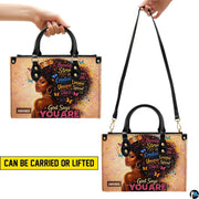 Two carry views of afro queen handbag with butterfly artwork
