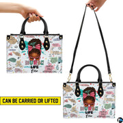 Side profile view of handbag showcasing continuous pastel medical doodle pattern