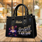 Illuminated cross and lily handbag resting on a wooden tabletop in a bright indoor room.