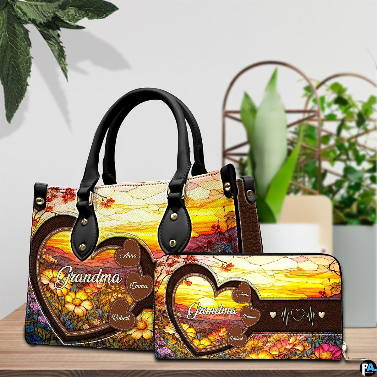 Upright showcase displaying stained glass floral sunrise artwork beside indoor garden foliage.
