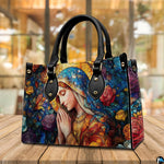 Stained glass Virgin Mary handbag staged outdoors on a wooden cafe patio table