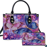 Twin crystal butterfly handbag and matching wallet set with blue and pink butterflies on lavender background.